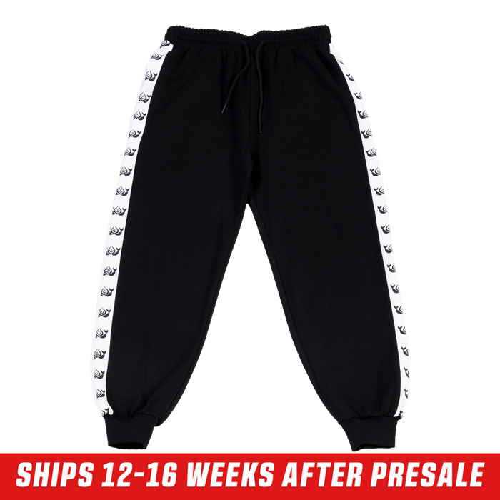 Black track pants with white side stripes featuring repeating killer whale silhouettes and a back pocket.